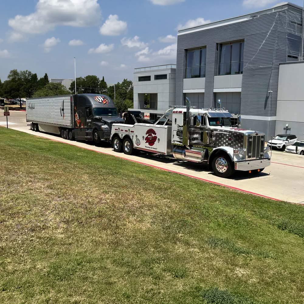 All American Towing hauling a fully loaded tractor trailer in Denton, Texas