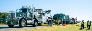 All American Towing Heavy Duty Wrecker Recovering a trash truck